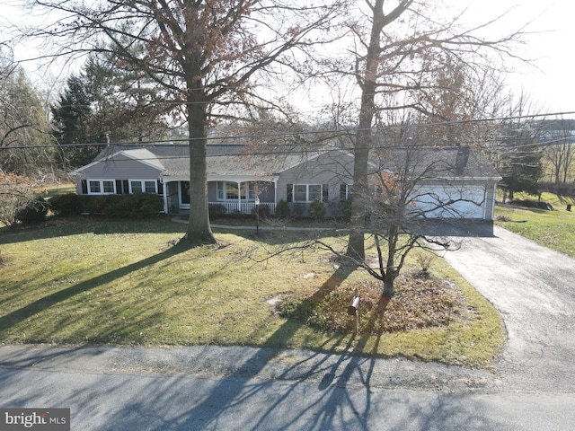 ranch-style home with a front yard, a porch, and a garage