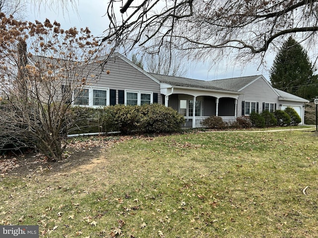 ranch-style home with a front yard and covered porch