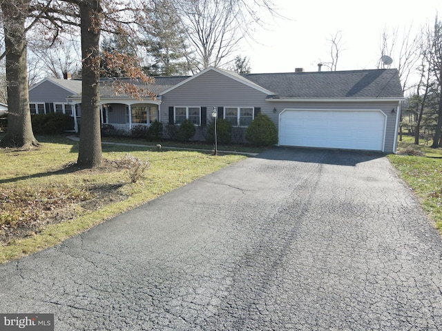 ranch-style home with a front lawn and a garage