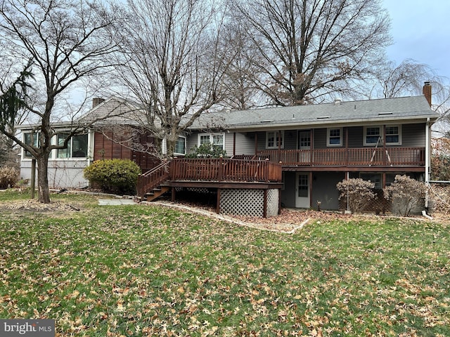 back of house with a lawn and a wooden deck