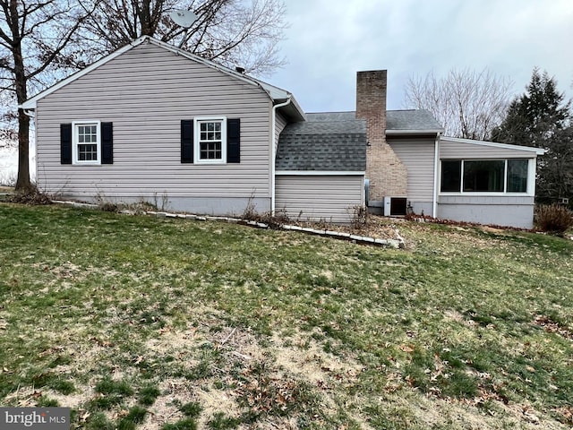 view of home's exterior with a lawn, a sunroom, and cooling unit