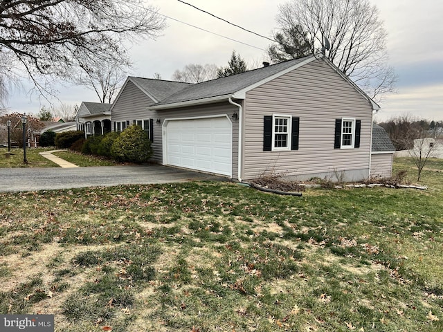 view of side of property with a garage and a yard