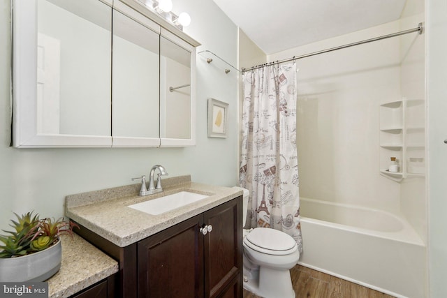 full bathroom featuring hardwood / wood-style floors, toilet, vanity, and shower / bath combo