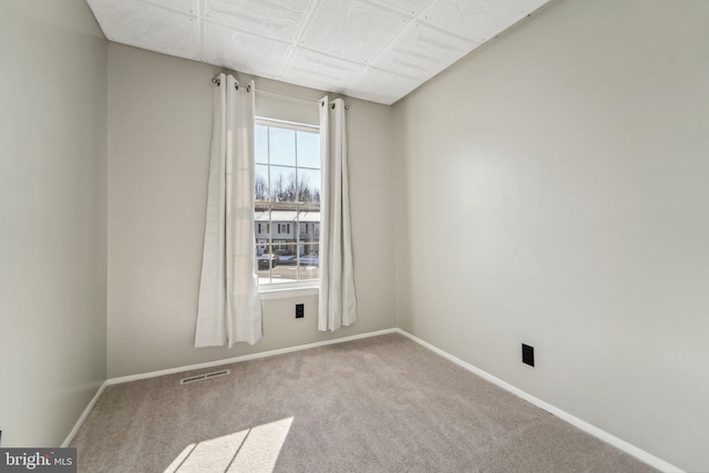 empty room featuring light carpet