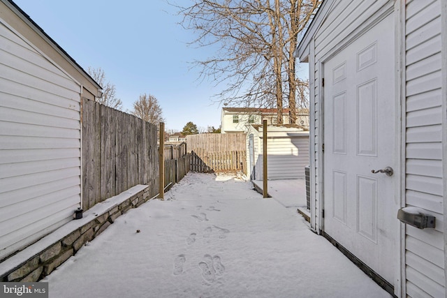 snowy yard with a shed