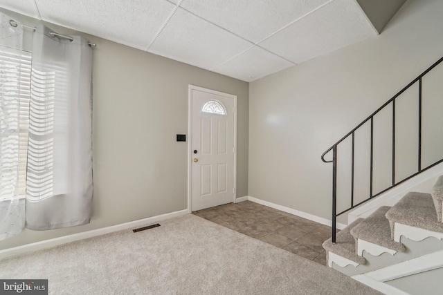 carpeted foyer entrance with a healthy amount of sunlight