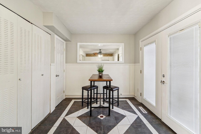 interior space with dark tile patterned flooring and french doors