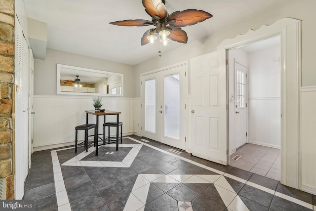 tiled entrance foyer featuring ceiling fan and french doors