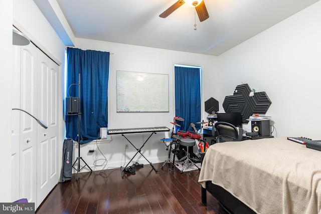 bedroom with a closet, ceiling fan, and dark wood-type flooring