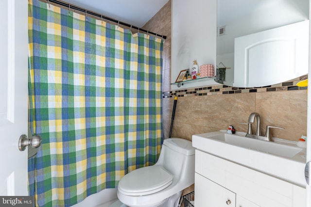 bathroom with a shower with curtain, vanity, tile walls, and toilet