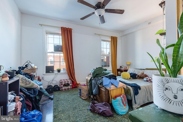 bedroom featuring multiple windows and ceiling fan