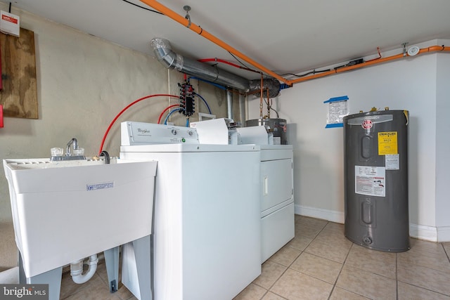 washroom featuring electric water heater, sink, water heater, light tile patterned floors, and separate washer and dryer