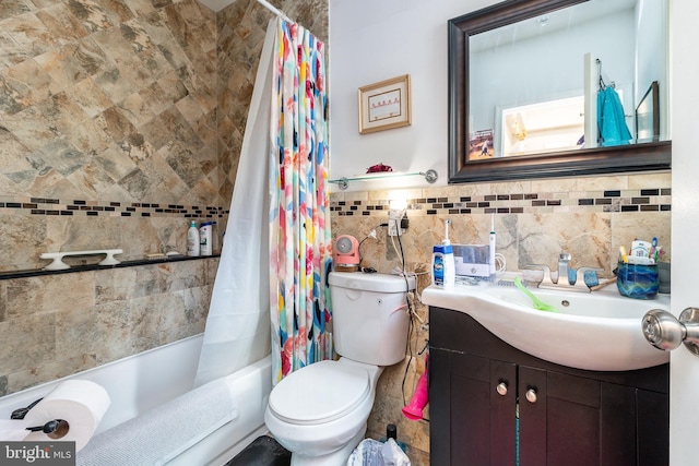 full bathroom with shower / tub combo, vanity, toilet, and tile walls