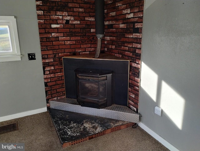 interior details featuring carpet flooring and a wood stove