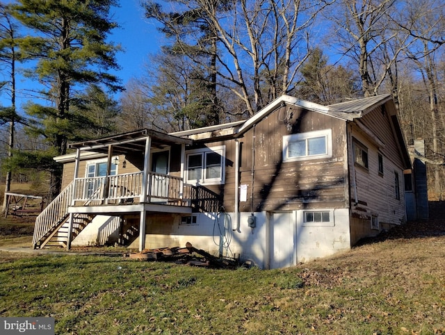 back of house with a lawn and a porch