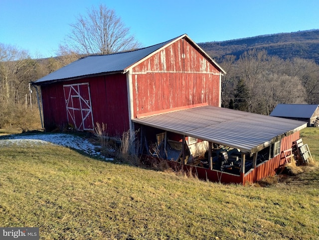 view of outbuilding with a lawn