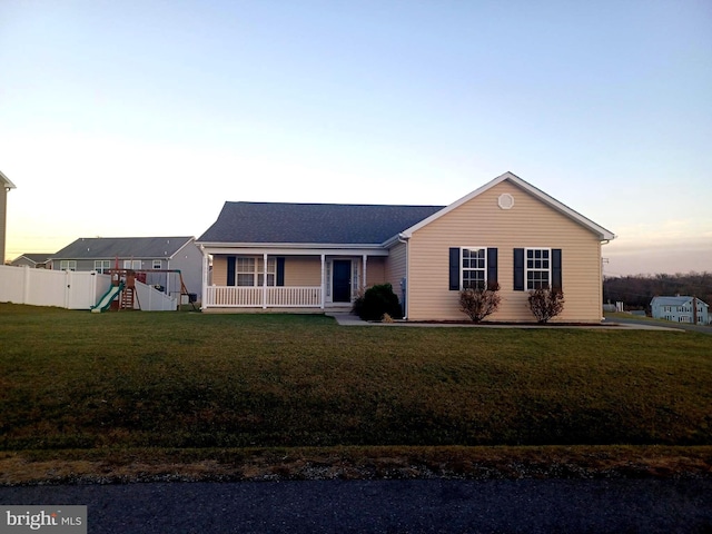 ranch-style home with a playground, a lawn, and a porch