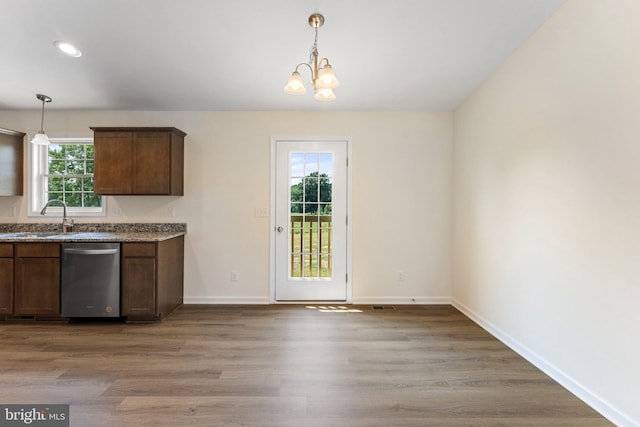 kitchen with sink, dishwasher, plenty of natural light, and hardwood / wood-style flooring