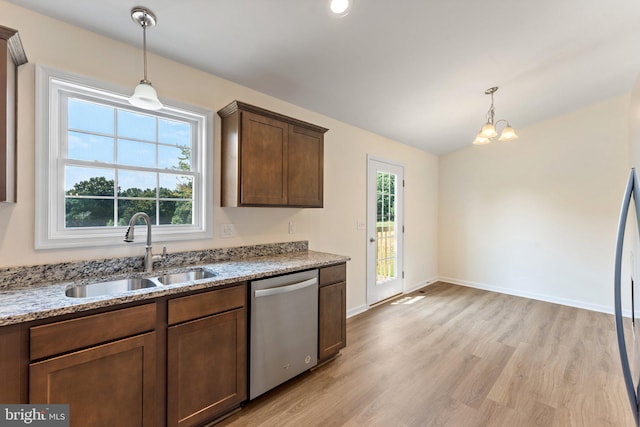 kitchen featuring a wealth of natural light, sink, stainless steel dishwasher, and light hardwood / wood-style flooring