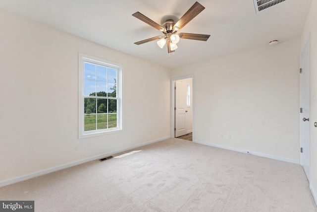 carpeted spare room featuring ceiling fan