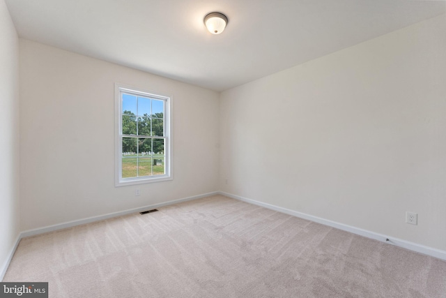 unfurnished room with light colored carpet