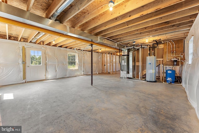 basement featuring heating unit and electric water heater