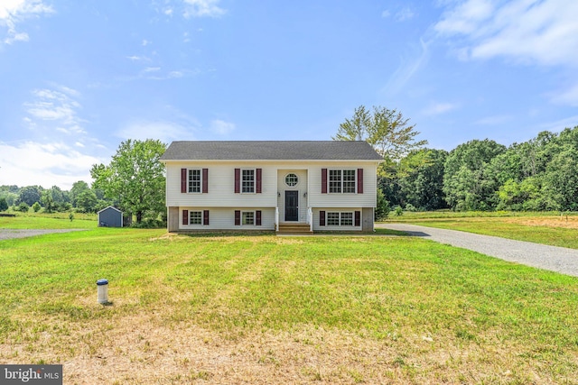 bi-level home with a shed and a front yard