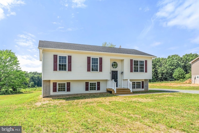 bi-level home with a front lawn