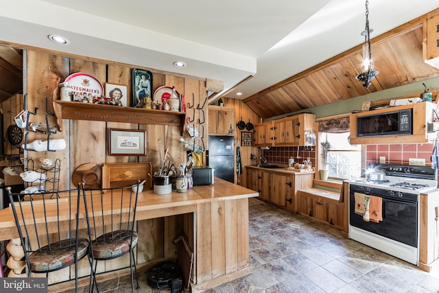 kitchen with vaulted ceiling, a breakfast bar, black appliances, decorative backsplash, and kitchen peninsula