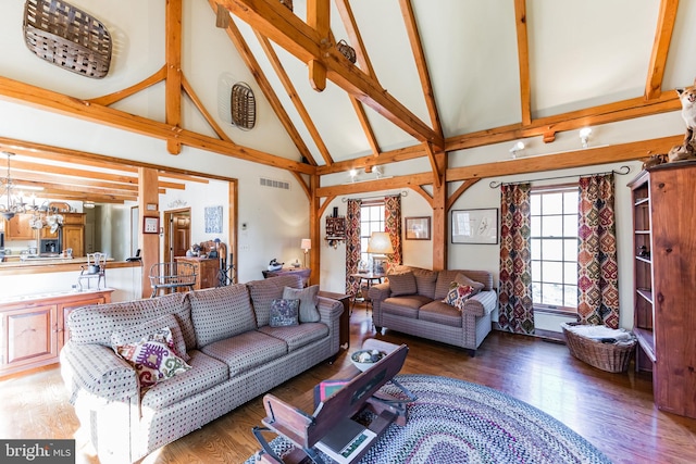 living room with beam ceiling, dark wood-type flooring, a chandelier, and high vaulted ceiling