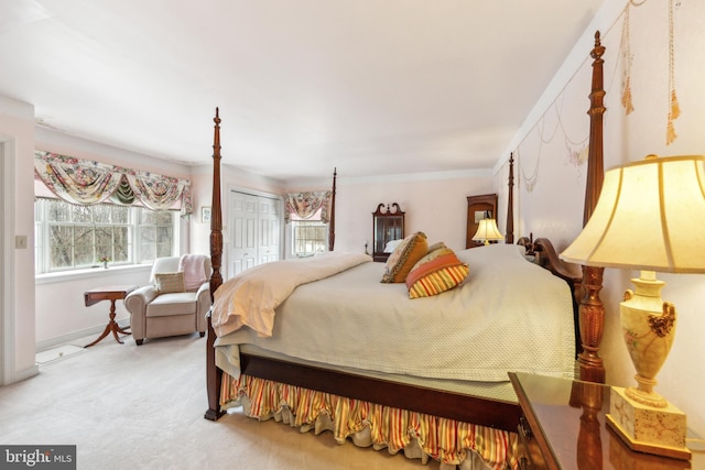 carpeted bedroom with ornamental molding and a closet