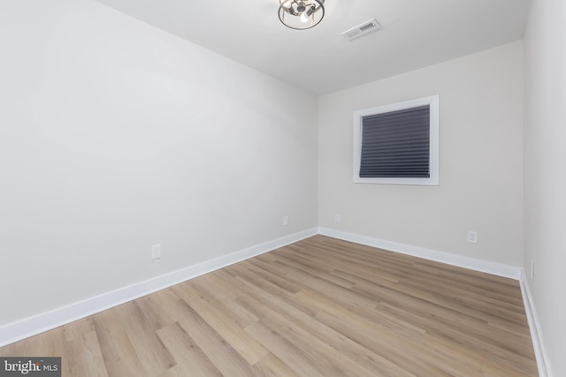 empty room with light hardwood / wood-style flooring