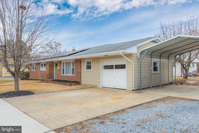 ranch-style house featuring a carport and a garage