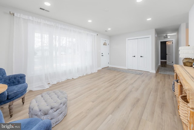 living area with light hardwood / wood-style flooring