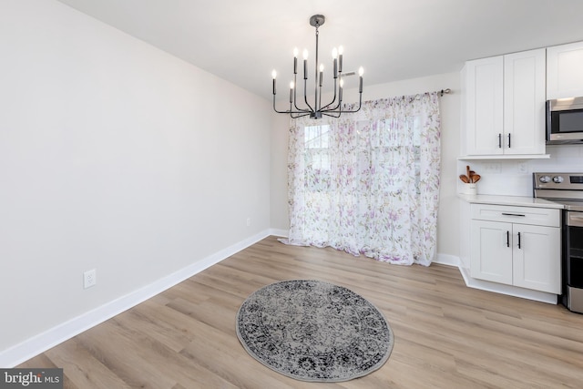 dining space featuring a chandelier and light wood-type flooring