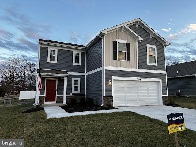 view of front of home featuring a front yard and a garage