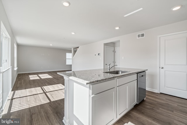 kitchen with stainless steel dishwasher, dark hardwood / wood-style flooring, sink, and a kitchen island with sink