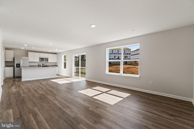 unfurnished living room featuring dark hardwood / wood-style floors