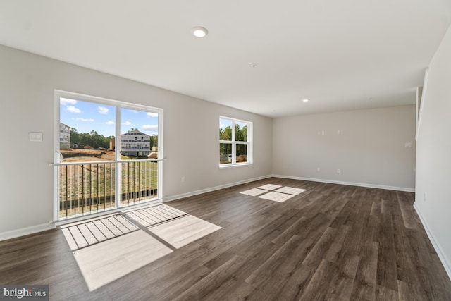 unfurnished room with dark hardwood / wood-style floors