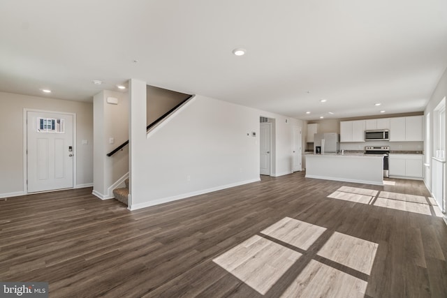 unfurnished living room with dark wood-type flooring