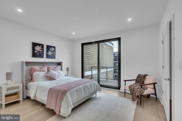 bedroom with access to outside and light wood-type flooring