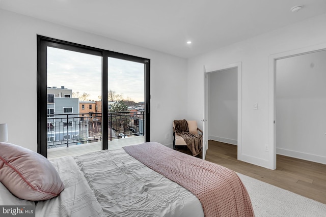 bedroom featuring access to outside and light hardwood / wood-style floors