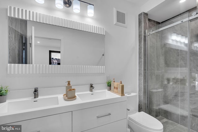 bathroom with vanity, walk in shower, and toilet