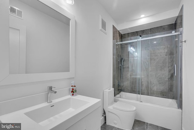 full bathroom with vanity, combined bath / shower with glass door, and toilet