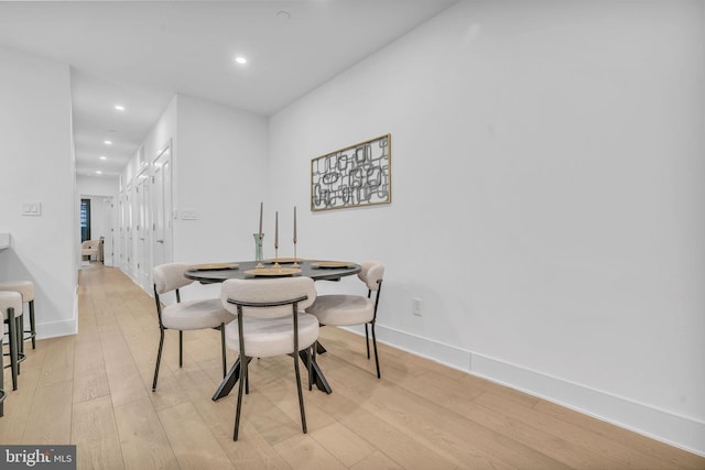 dining space with light hardwood / wood-style flooring