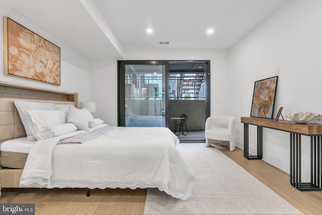 bedroom featuring light hardwood / wood-style flooring and access to outside