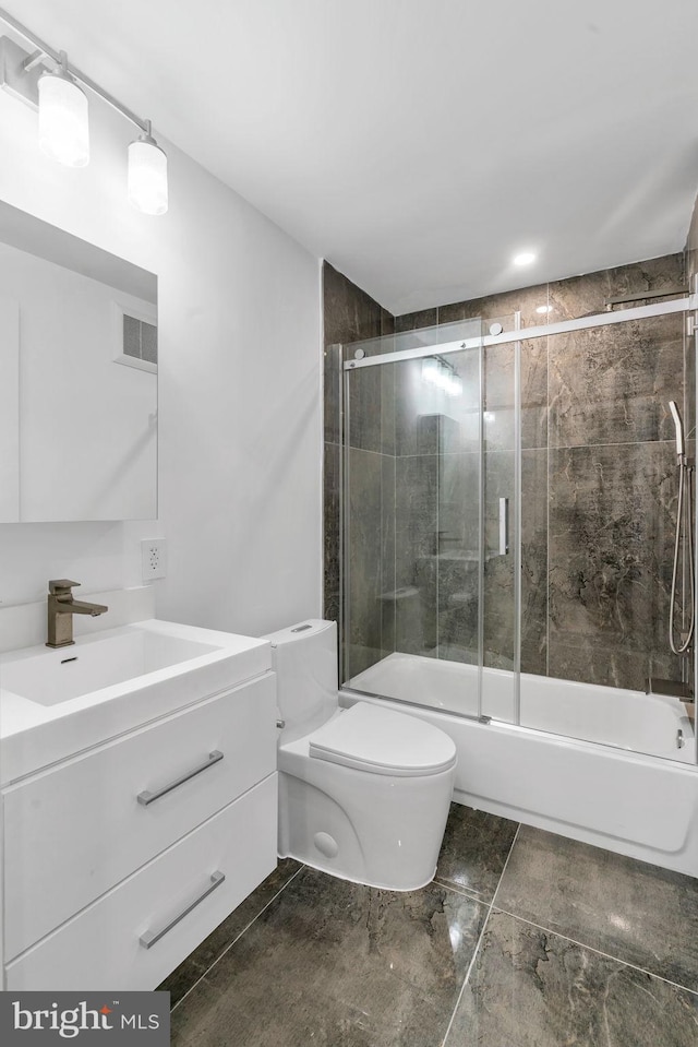 full bathroom with vanity, shower / bath combination with glass door, and toilet