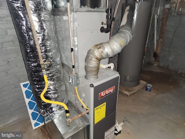 utility room with heating unit and water heater