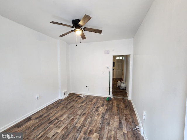 empty room featuring ceiling fan and dark hardwood / wood-style flooring