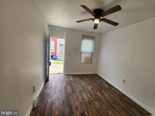 empty room featuring ceiling fan and dark wood-type flooring